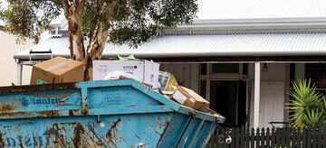 Skip bin out the front of a house